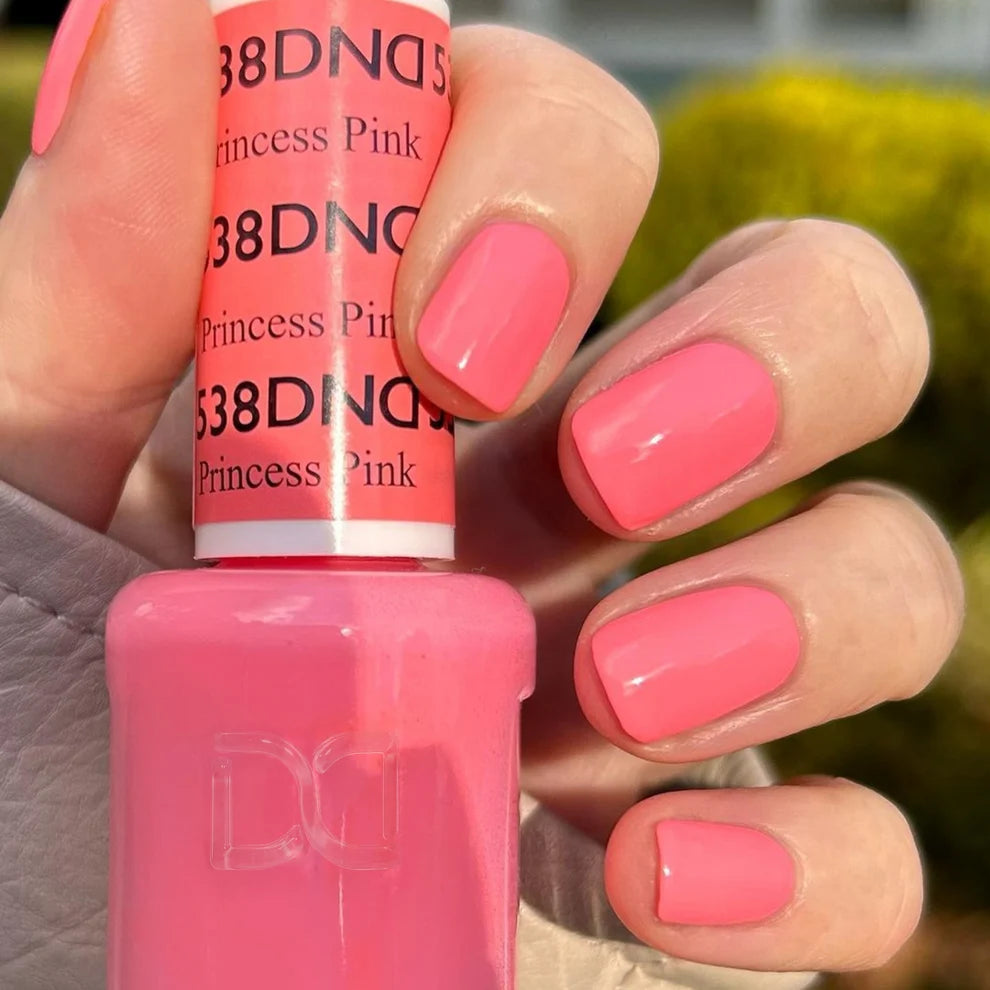 Manicured hand wearing DND Princess Pink #538 gel polish, showing the bubblegum pink shade with peach undertones on the nail