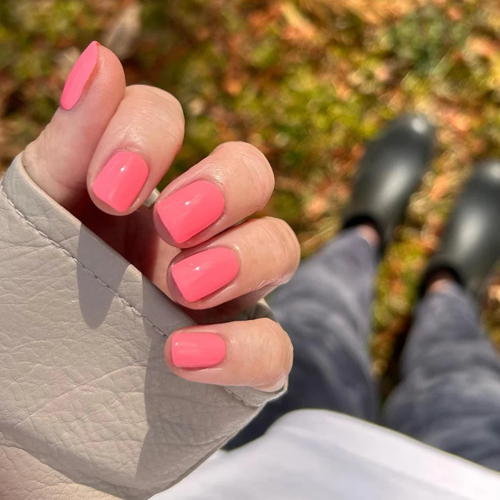 Manicured hand wearing DND Princess Pink #538 gel polish, showing the bubblegum pink shade with peach undertones on the nail