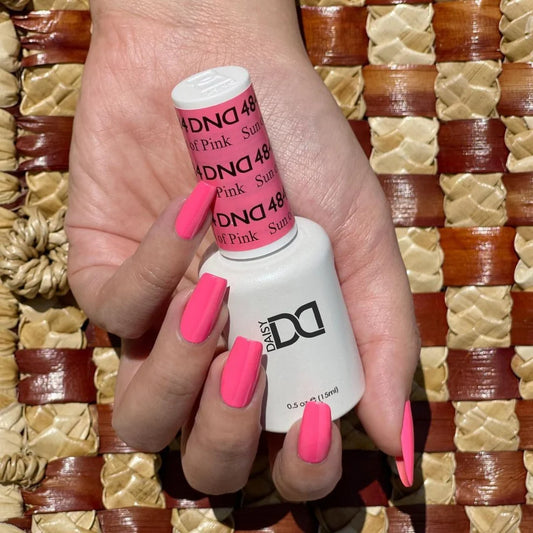 Bright pink manicure featuring DND Sun Of Pink #484 with the matching Gel & Lacquer Duo.
