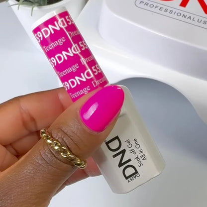 Close up manicure shot of DND Teenage Dream #559 on the nail, highlighting the vibrant neon finish and cool pink tone