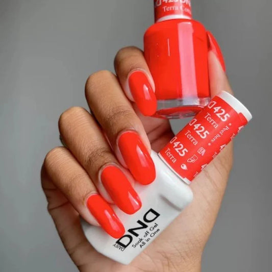 Manicure featuring DND Terra Cotta #425 while holding the matching Gel & Lacquer Duo.