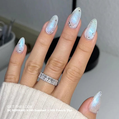 A close-up of a hand with long almond-shaped nails painted in a shimmering iridescent silver and blue gel polish, with DND gel top coat 600