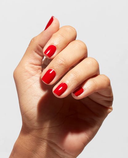 Hand with red nail polish on a light gray background