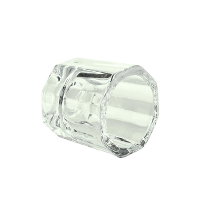 Clear glass dappen dish on a white background