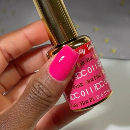 Manicured hand wearing DC Jelly 011 Hot Pink jelly gel polish to show the bold watermelon hot pink finish in natural light