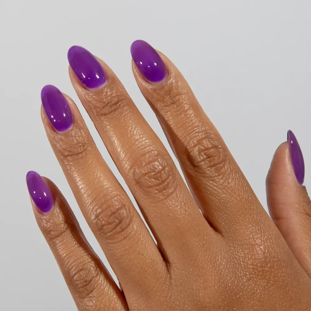 Manicured hand wearing DC Jelly 019 Iris jelly gel polish to show the dreamy soft purple glow in natural light