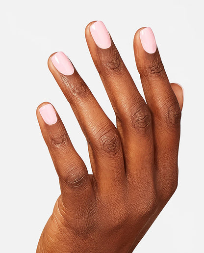 Hand with light pink OPI it's a girl nail polish on a neutral background