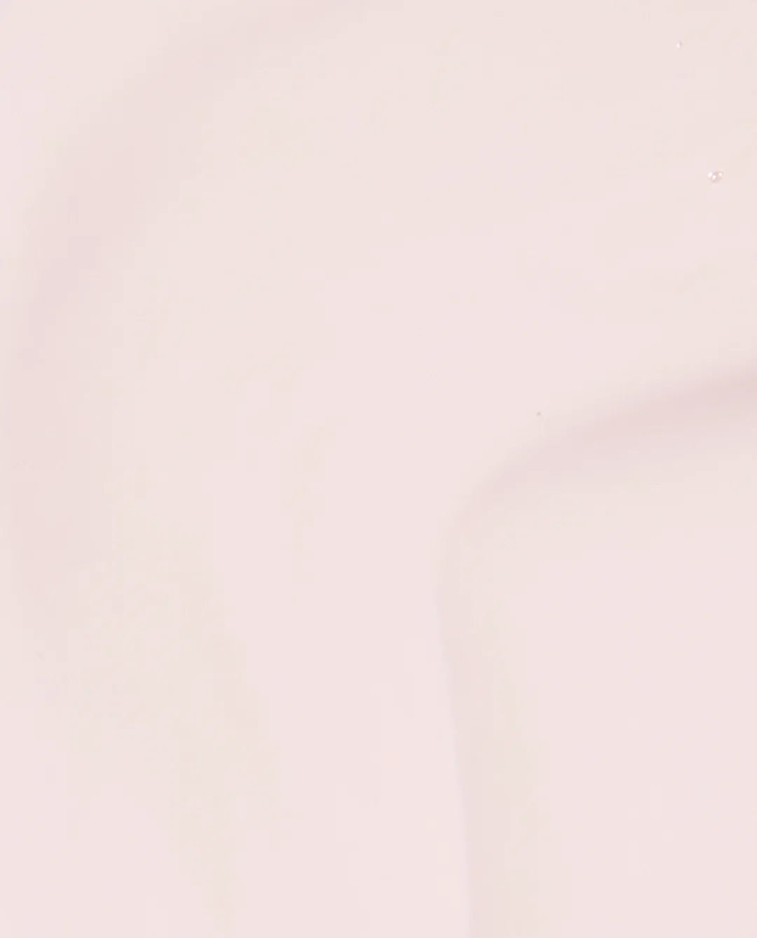 A close-up of a solid, very pale blush pink surface with soft shading for 