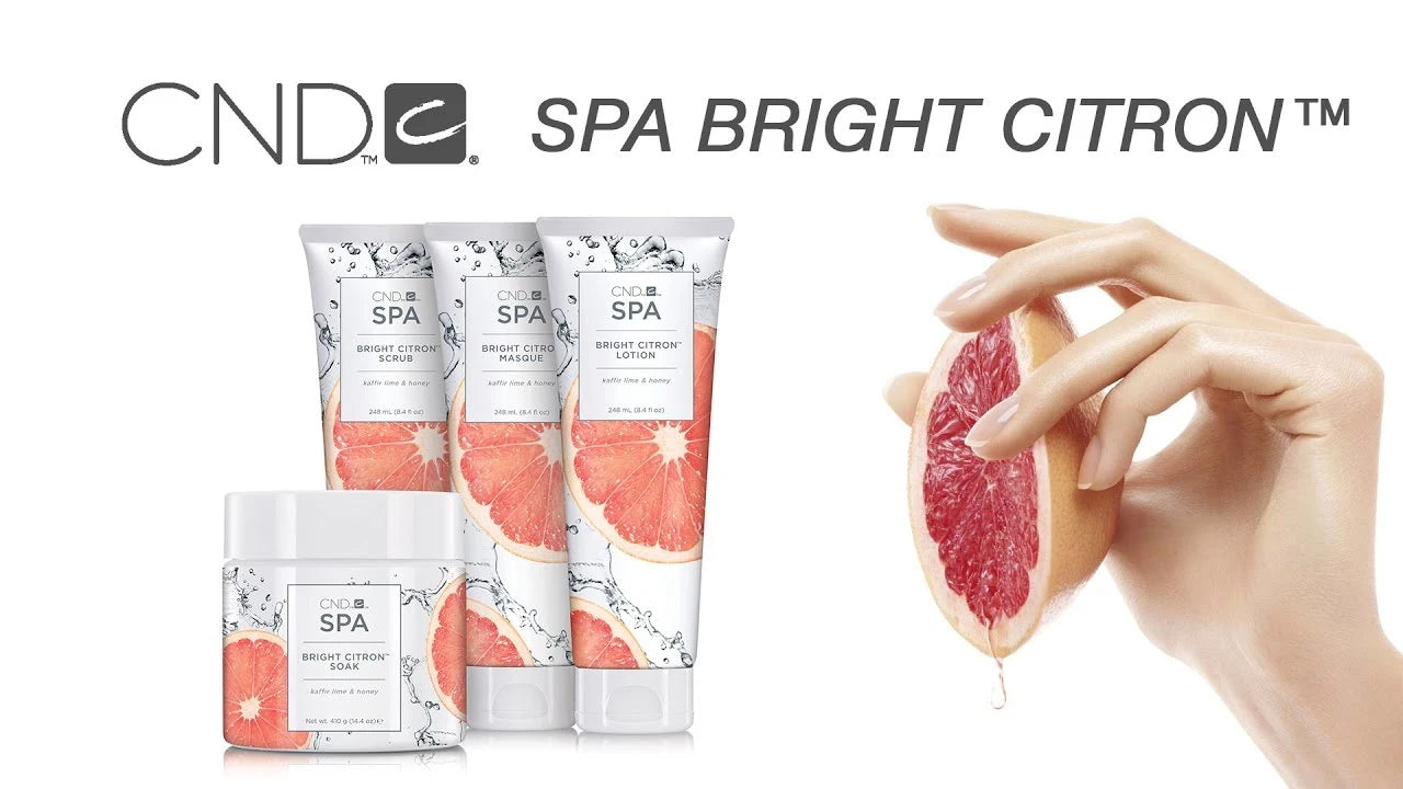 CND Spa Bright Citron skincare products with a hand holding a grapefruit on a white background