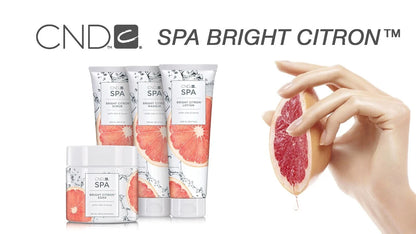 CND Spa Bright Citron skincare products with a hand holding a grapefruit on a white background
