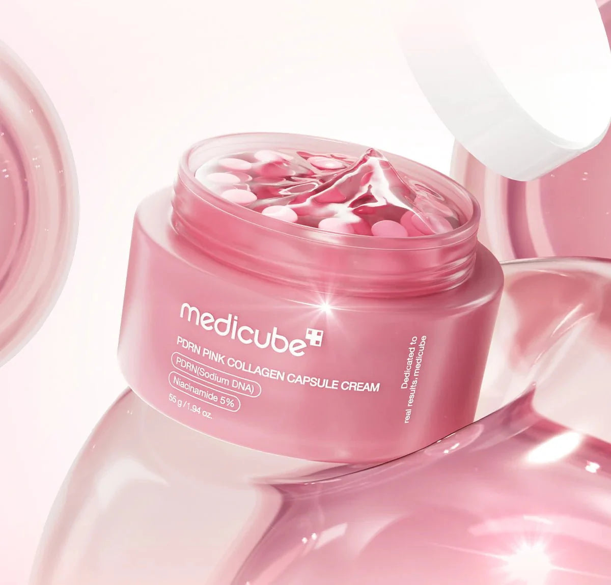 Open jar of Medicube collagen cream showing the pink capsules inside