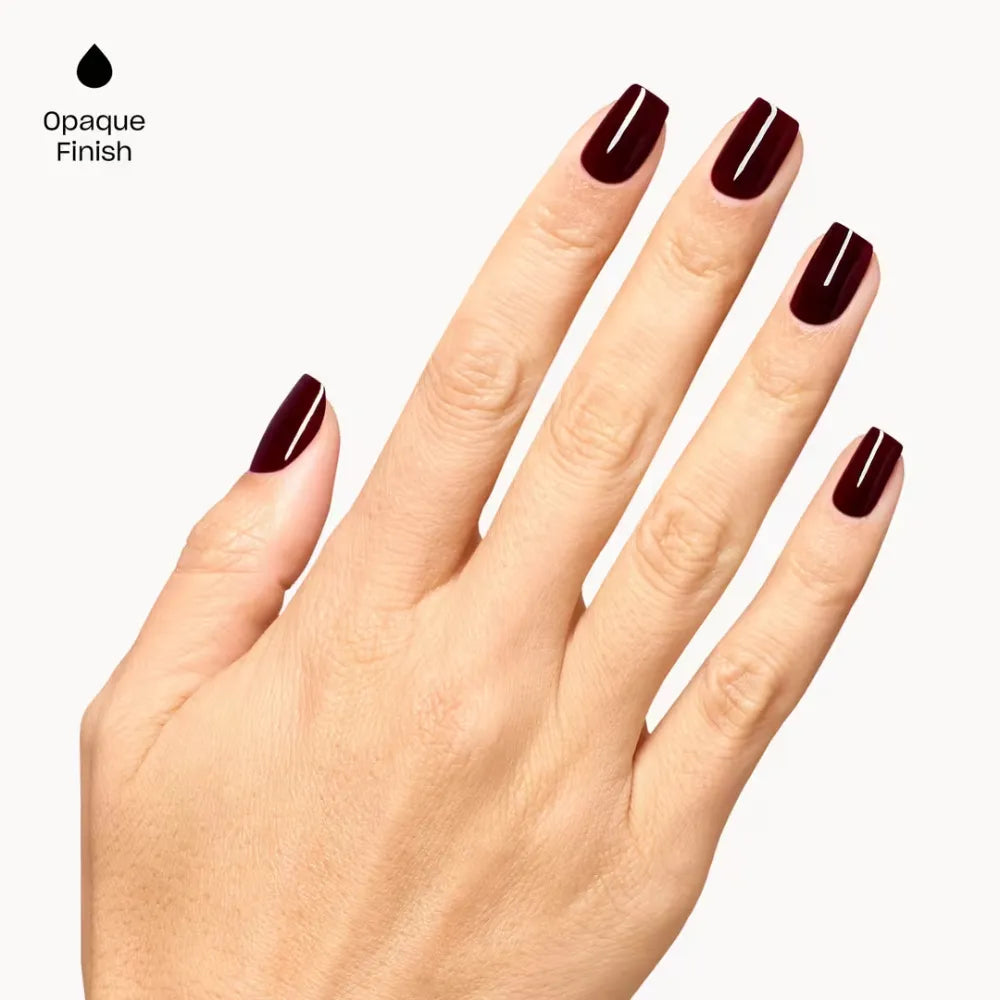 A hand with manicured nails painted in OPI Mrs. O’ Leary’s BBQ a deep opaque burgundy shade, shown against a light gray background with the text 'Opaque Finish' and a black droplet icon in the upper left.