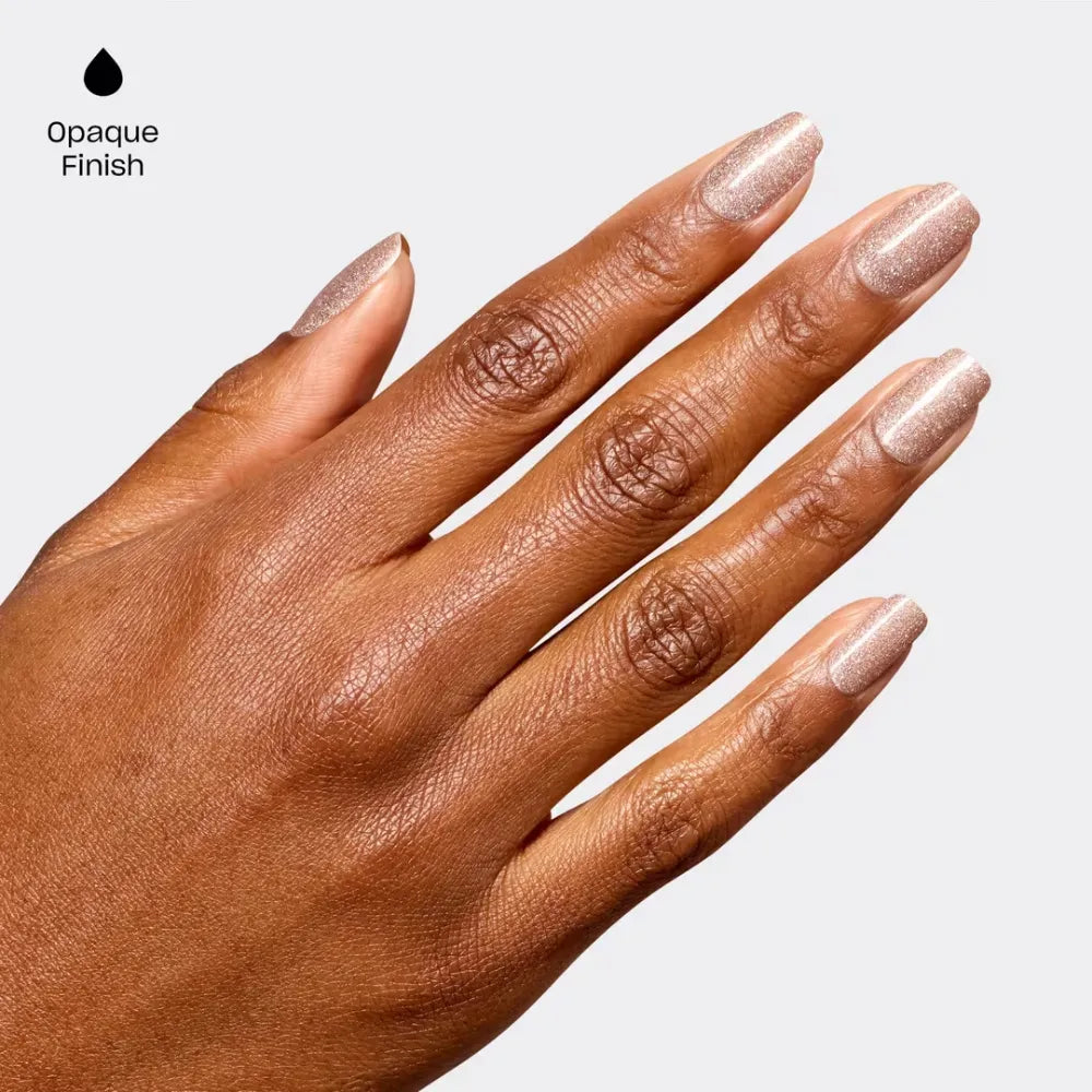 A close-up of a hand with long, glossy nude-rose manicured nails, shown against a light gray background with the text 'Opaque Finish' and a black droplet icon in the upper left corner.