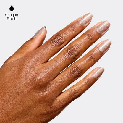A close-up of a hand with long, glossy nude-rose manicured nails, shown against a light gray background with the text 'Opaque Finish' and a black droplet icon in the upper left corner.