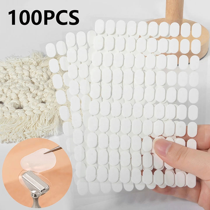 Packaging of 100 white Nail display stand stickers strong hold no residue on white background.