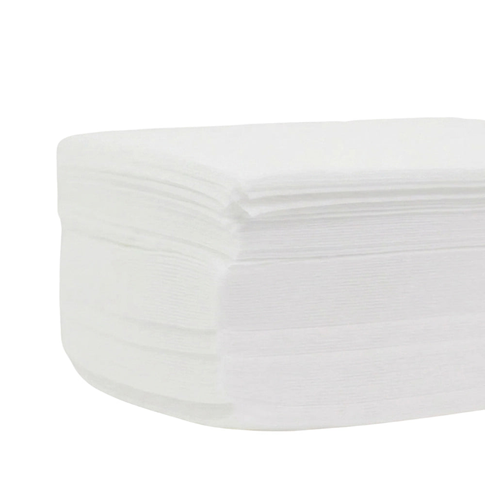 Non-woven epilating strips laid flat showing lint-free fabric surface and pre-cut 3 by 9 inch size

