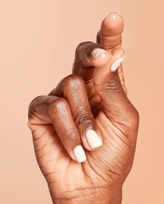 Manicured hand showing OPI E82 creamy nude gel polish applied to fingernails