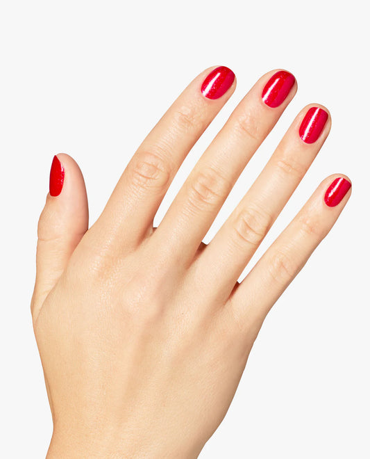 Gel manicure on natural nails displaying OPI GelColor Big Apple Energy shimmery red glossy finish and bold coverage.
