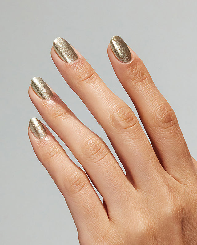 Close up of fingernails painted with OPI GelColor metallic gold gel polish showing a shimmery finish