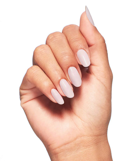 Natural manicure on hands displaying OPI Pink In Bio glossy finish with smooth even application coverage.
