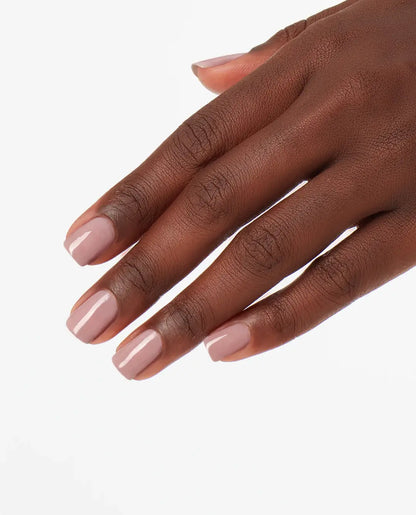 Manicure hand with light pink OPI Put It In Neutral GelColor T65 nail polish on a white background