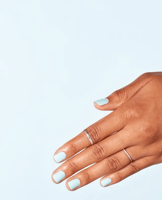 Manicured nails painted with OPI T75 baby blue gel polish showing the soft pastel color