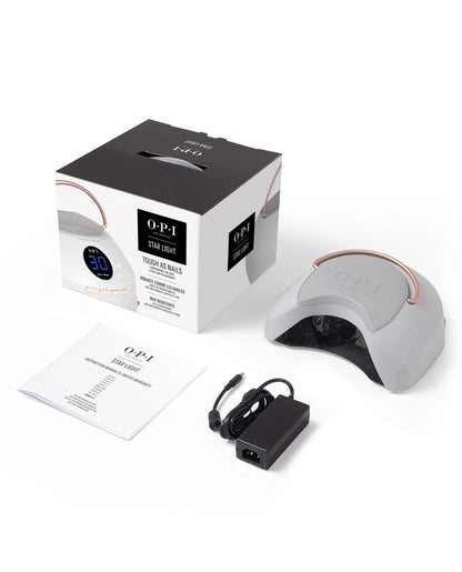 OPI nail lamp with packaging and power cord on a white background