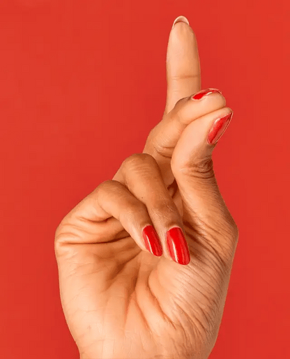 Manicured nails painted with OPI V30 red shimmer gel polish showing the sparkling finish