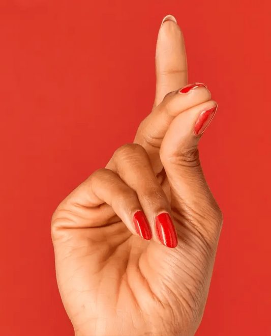 Manicured nails painted with OPI V30 red shimmer gel polish showing the sparkling finish