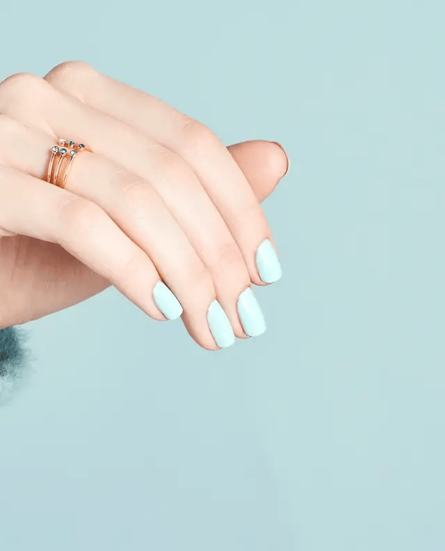 Manicured nails painted with OPI V33 pastel blue gel polish showing the icy cool color