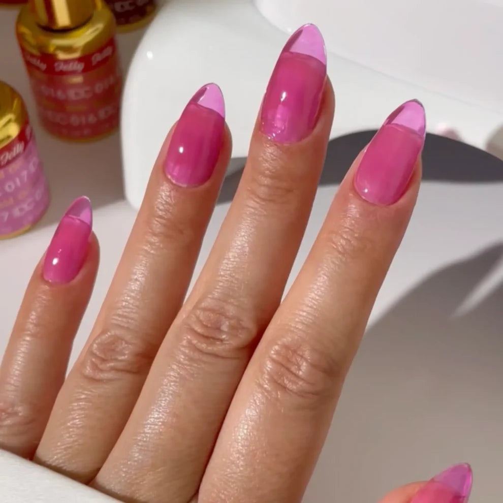 Manicured hand with light skin tone wearing DC Jelly 017 Orchid jelly gel polish in a pink purple finish