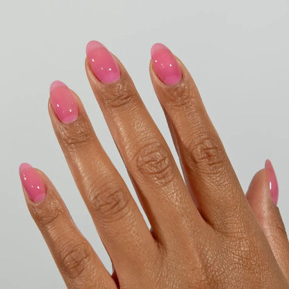 Manicured hand wearing DC Jelly 017 Orchid jelly gel polish to show the playful orchid purple glow in natural light