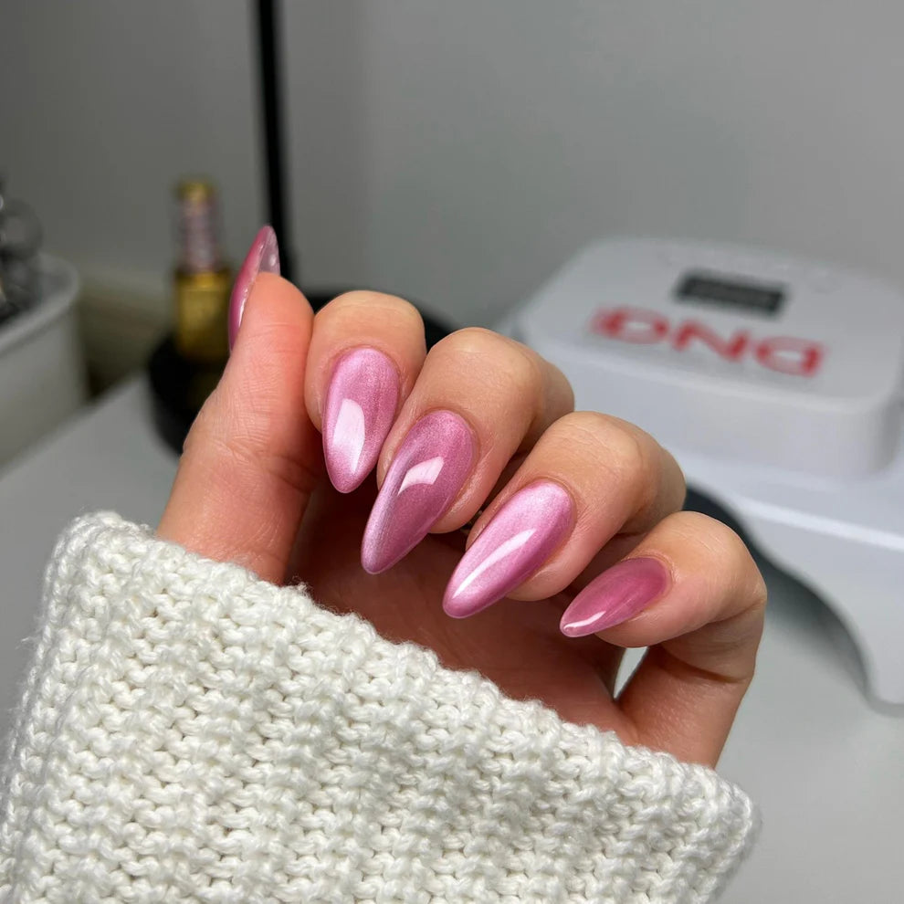 pink cat eye nails on manicured hand wearing DND DIVA #08 Kitty Blossom
