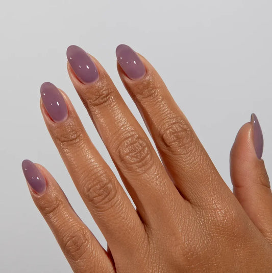Manicured hand wearing DC Jelly 026 Plum Haze jelly gel polish to show the berry dreamy plum finish in natural light