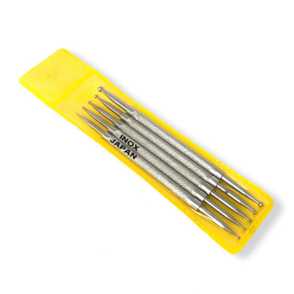 A set of five silver stainless steel engraving needles in a bright yellow plastic case, with 'INOX JAPAN' printed on the side, shown on a white background.