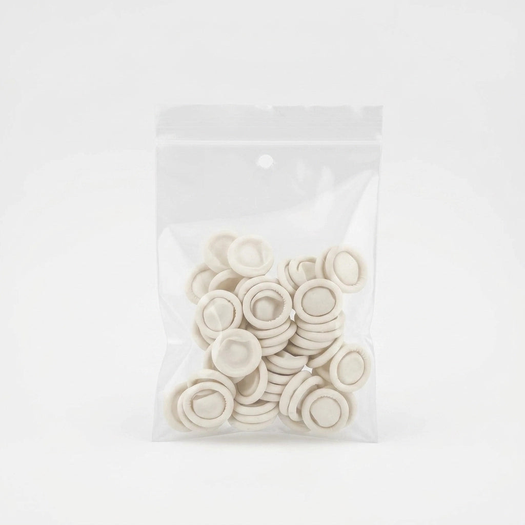 Pack of white rubber finger protectors for salon hygiene and safety