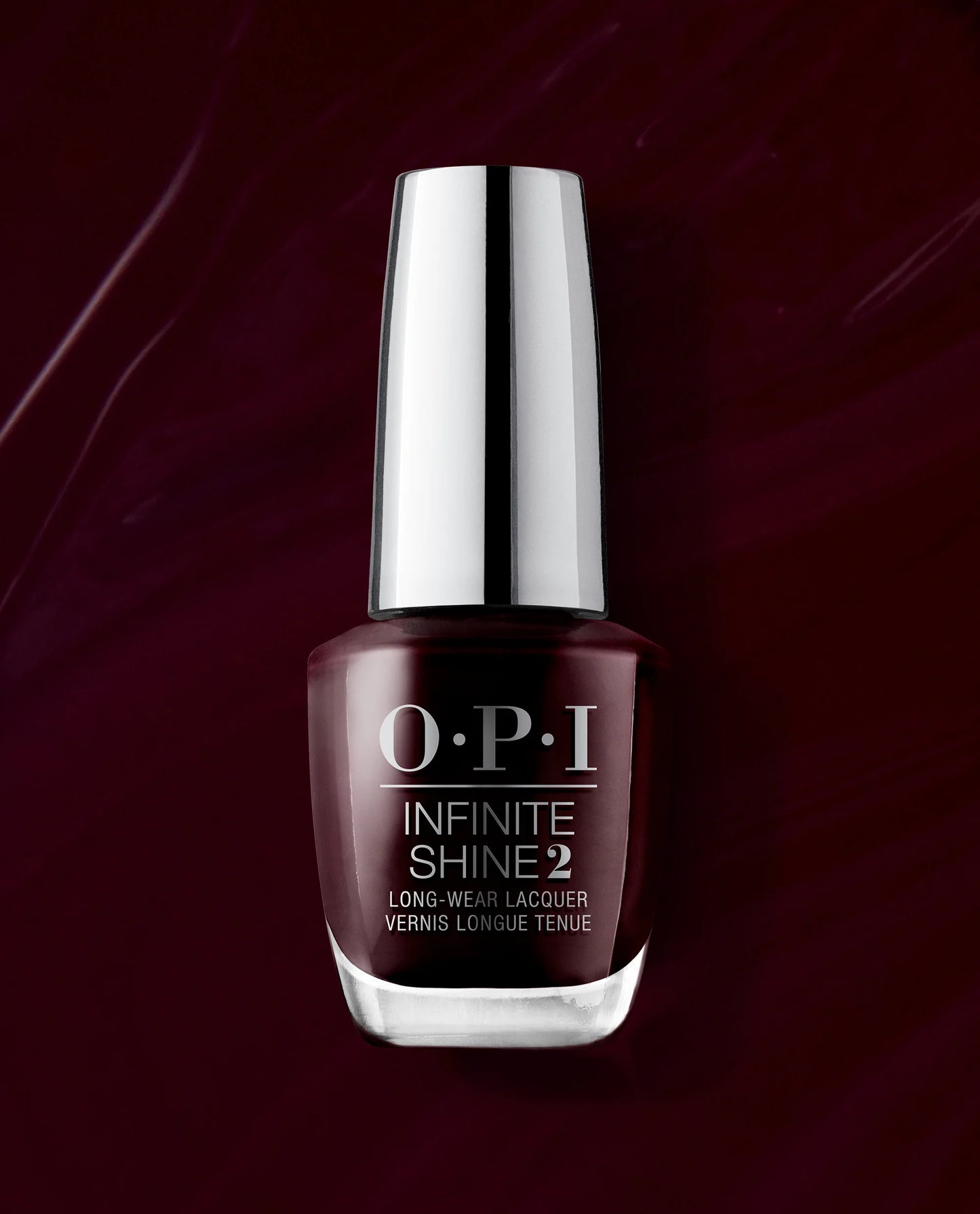 OPI Infinite Shine 2 Long-Wear Lacquer nail polish in a deep burgundy shade, featuring a reflective silver cap, set against a dark burgundy background with a subtle polish smear.