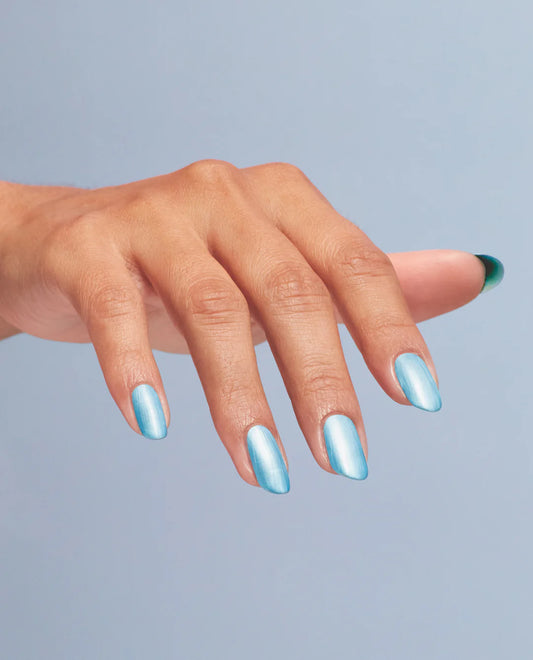 Hand with blue nail polish on a light gray background