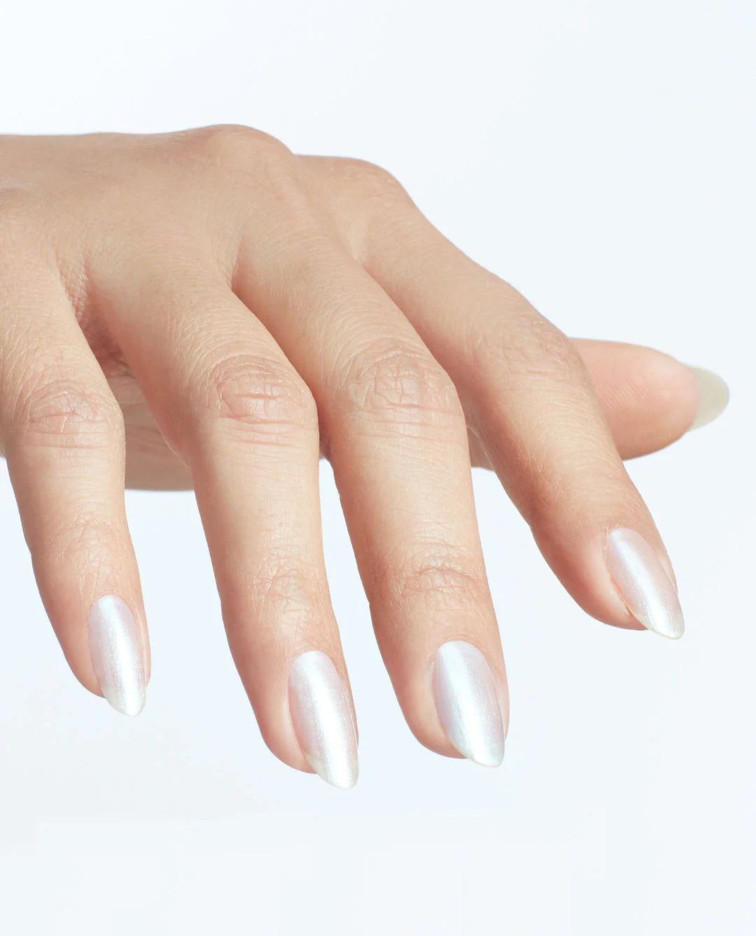 Hand with long, pointed nails on a light background
