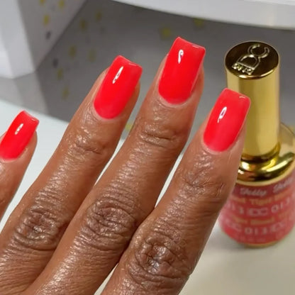 Manicured hand with dark skin tone wearing DC Jelly 013 Tiger Blood jelly gel polish in a fiery orange red finish
