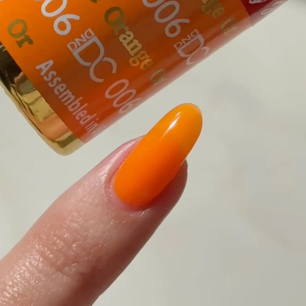 Swatch of DC Jelly 06 Orange jelly gel polish applied on a nail tip to show the true orange color and creamy finish