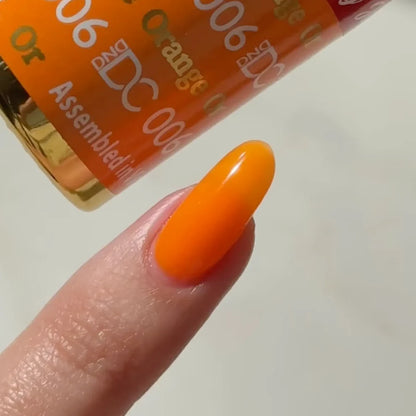 Swatch of DC Jelly 06 Orange jelly gel polish applied on a nail tip to show the true orange color and creamy finish