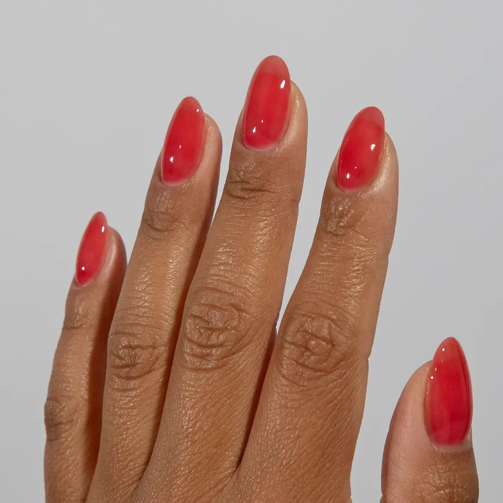 Manicured hand wearing DC Jelly 015 Wildberry jelly gel polish to show the berrylicious creamy jelly finish in natural light