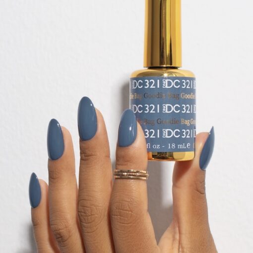 Manicure featuring DND DC Goodie Bag #321 painted on natural nails in a denim blue tone