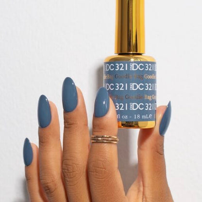 Manicure featuring DND DC Goodie Bag #321 painted on natural nails in a denim blue tone